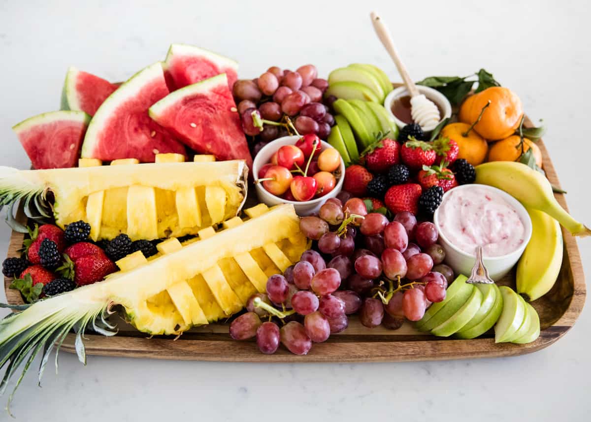 Fresh fruit platter on wood board.