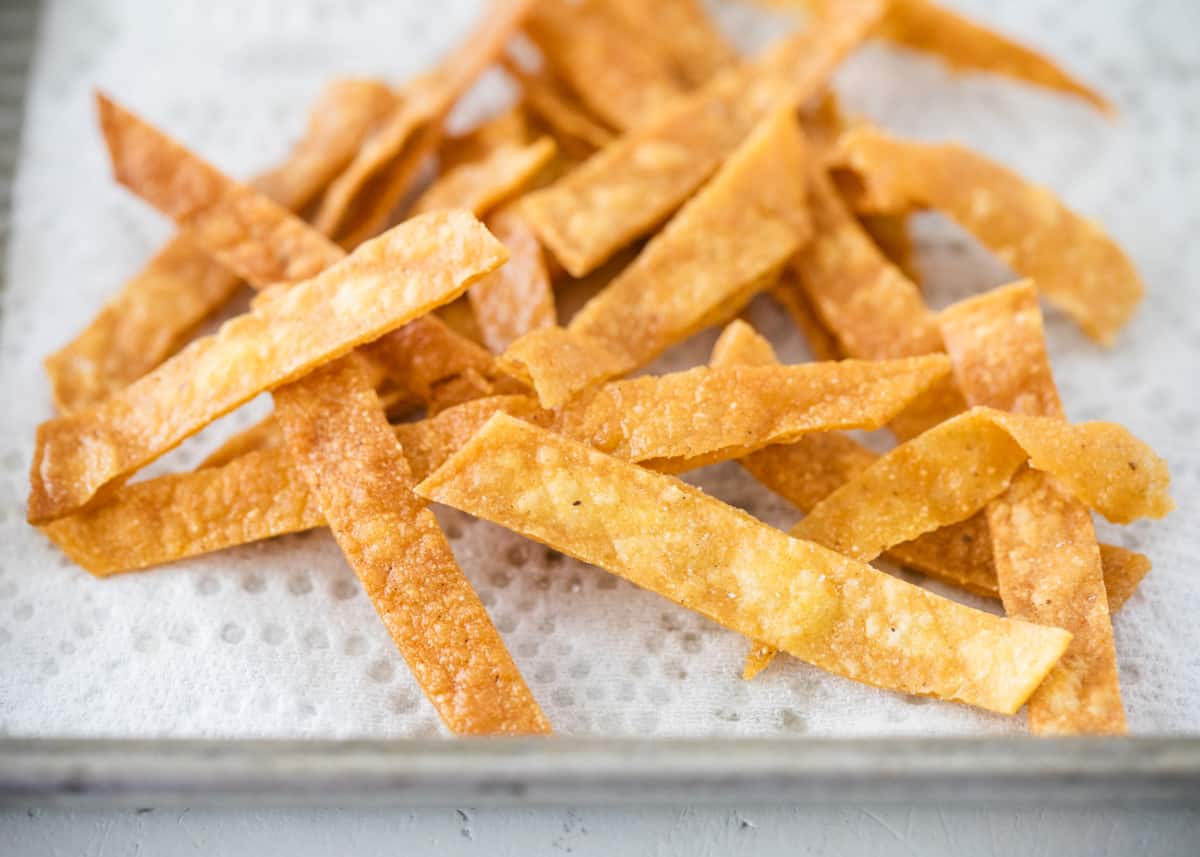 Crispy tortilla strips on a baking sheet.