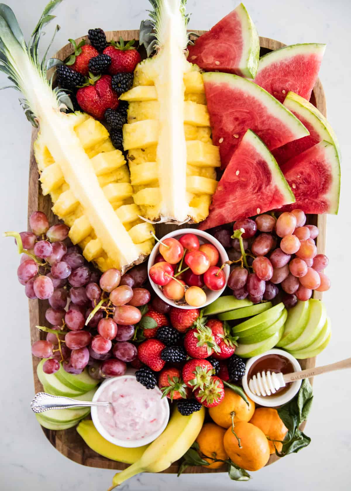 Fruit platter on wooden board.