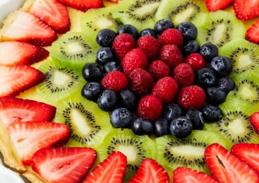 Fruit tart in a white dish.