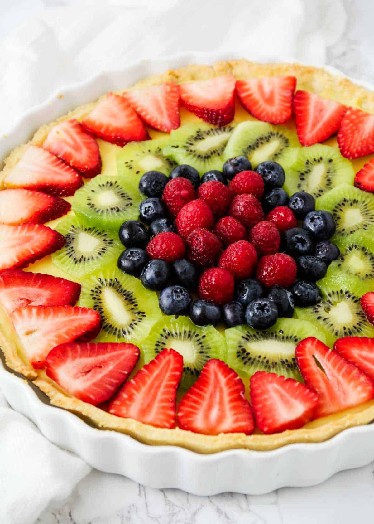 Fruit tart in a white dish.