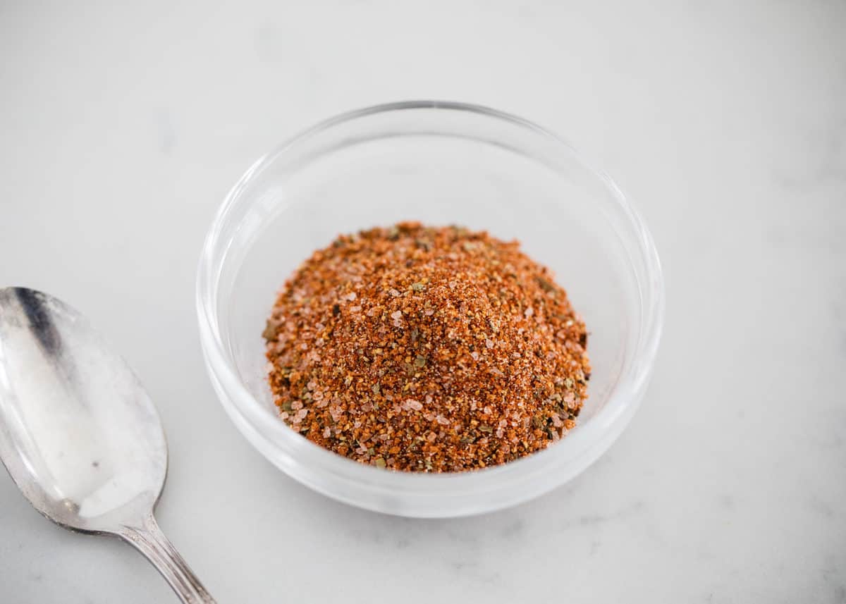 Hamburger seasoning in a glass bowl.