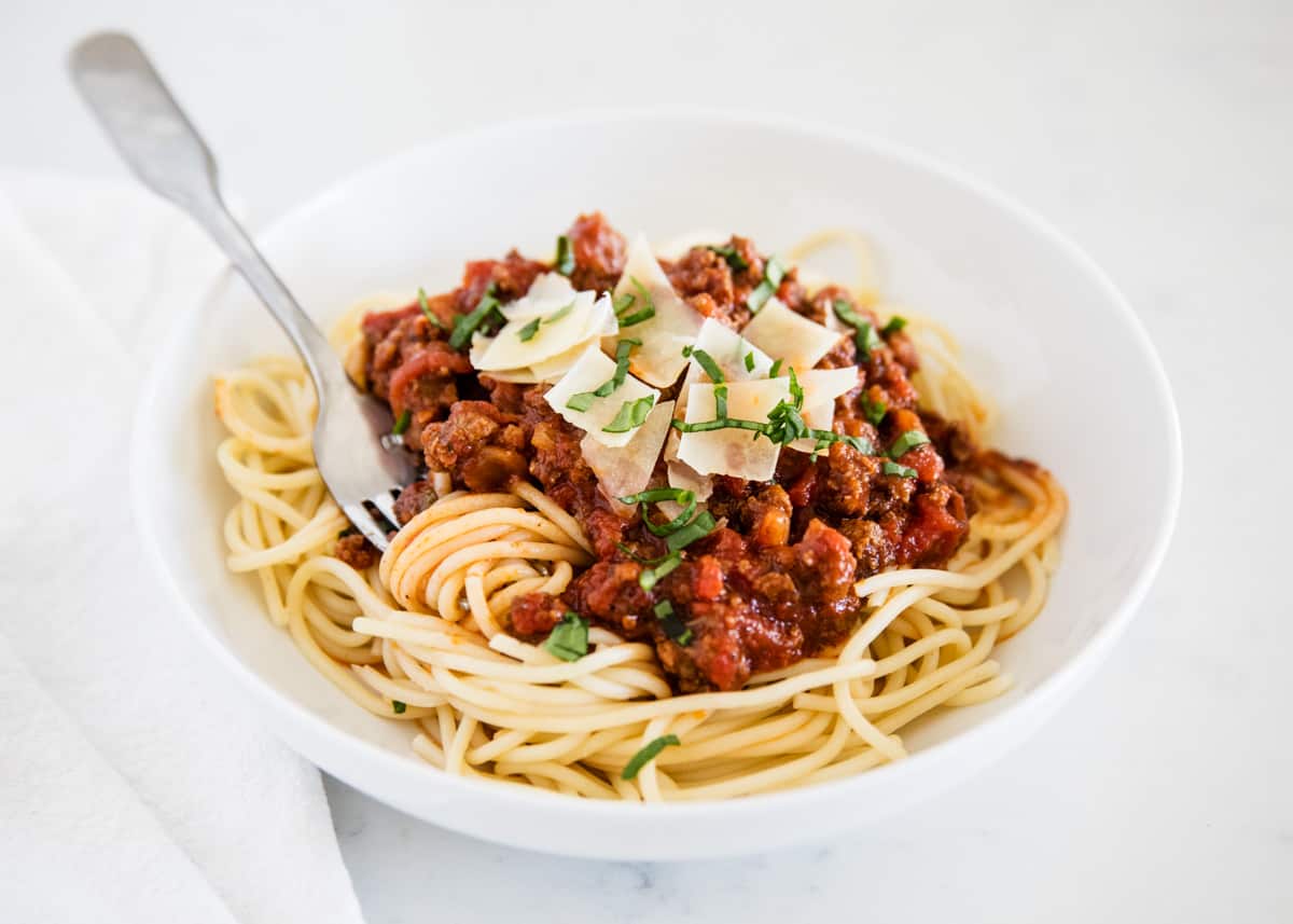 Homemade spaghetti on white plate.