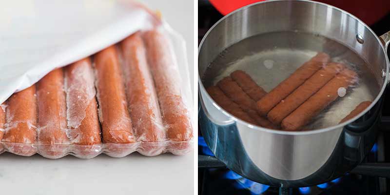 Boiling frozen hot dog in water.