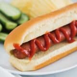 hot dog on white plate