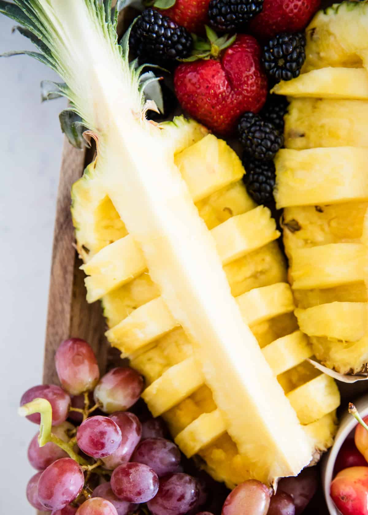 Cut pineapple on fruit platter.
