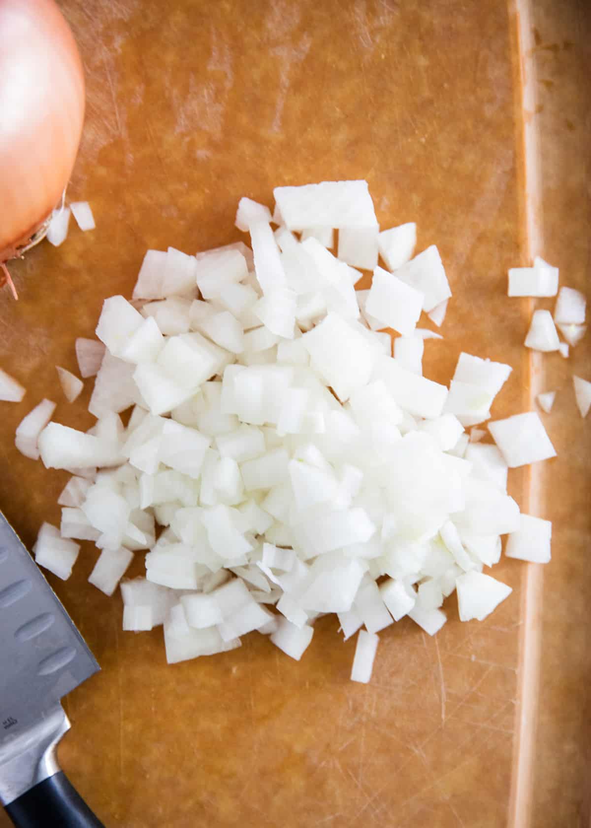 Dicing onions on cutting board.