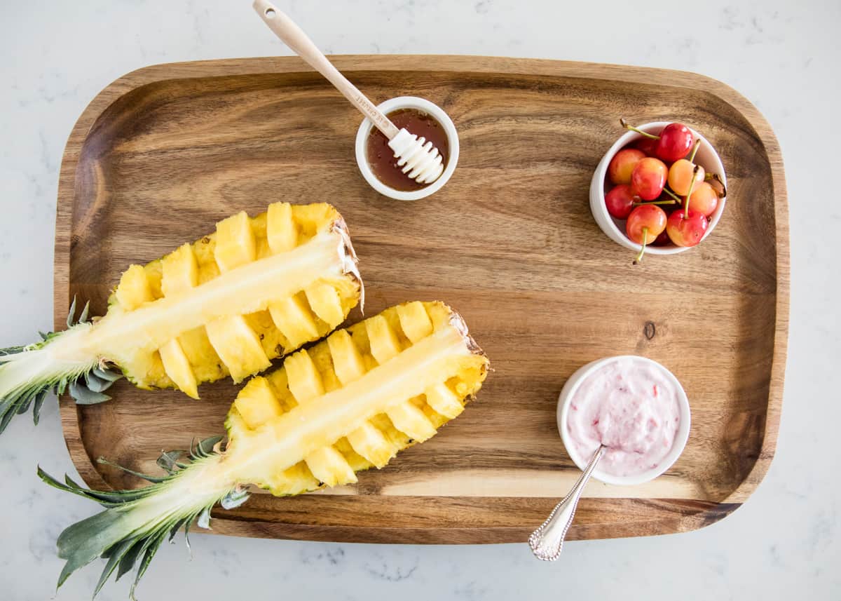 Arranging fruit on a wooden board.