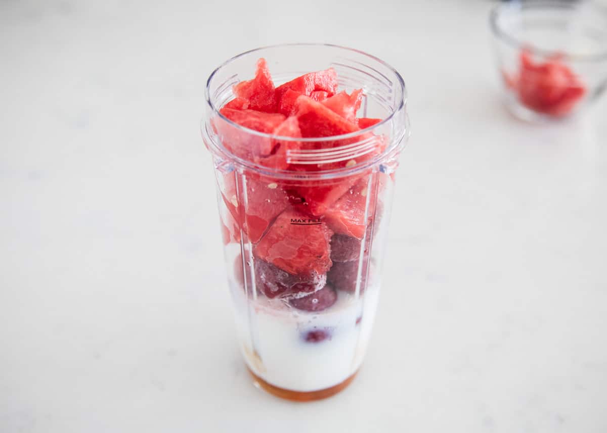 This watermelon smoothie is the perfect drink on a hot summer day! It's cold, creamy, naturally sweet and super refreshing. It has the perfect amount of watermelon flavor. Watermelon smoothie in a blender cup.