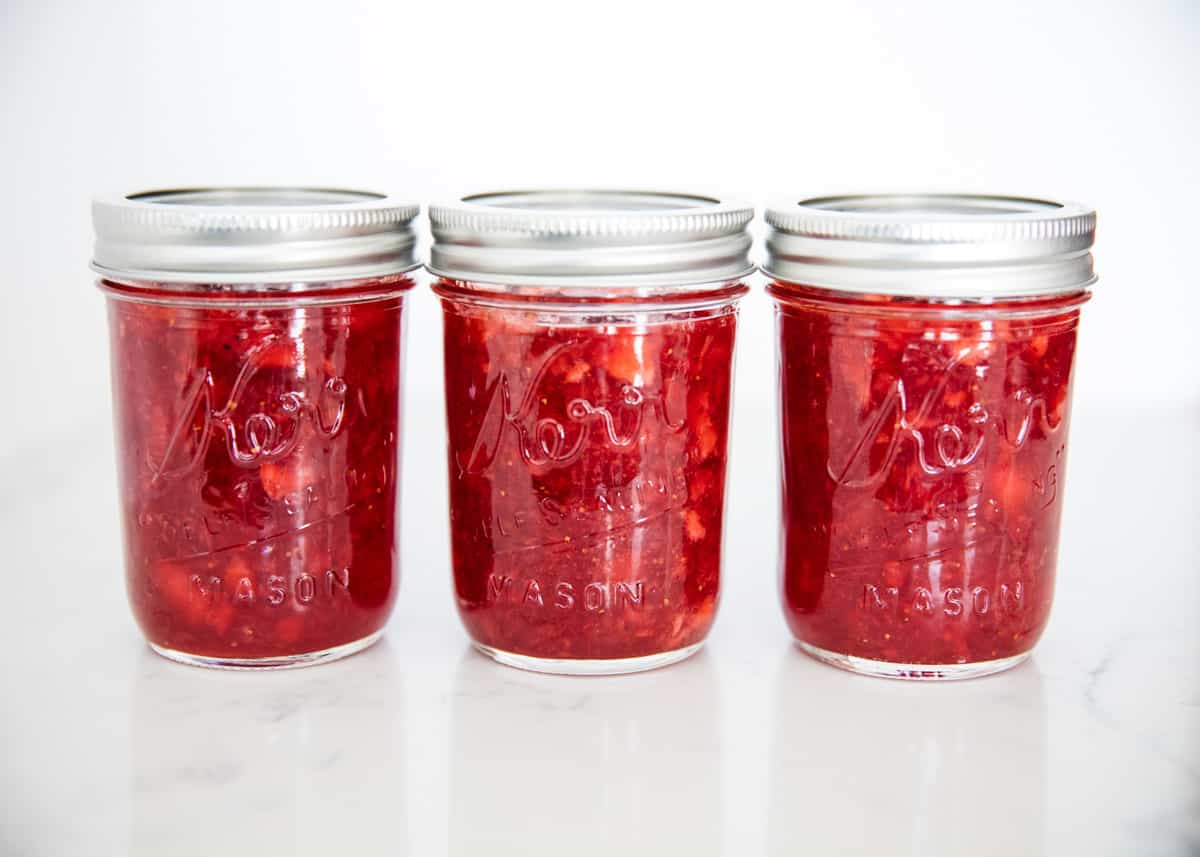 The best homemade strawberry jam that's easy to make with only four ingredients! Full of fresh sweet berry flavor, it beats out store bought any day. Strawberry jam in jars.