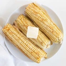 grilled corn on white plate