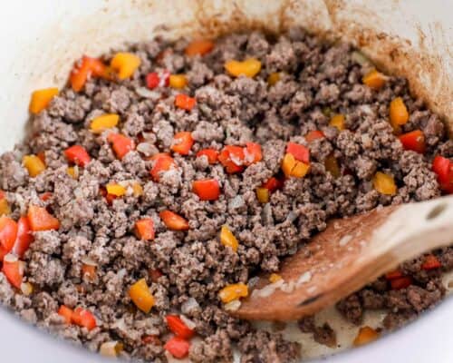 cooking hamburger and peppers in pan