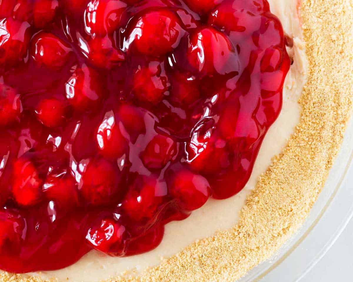 Cherry cheesecake dip in glass pie dish.