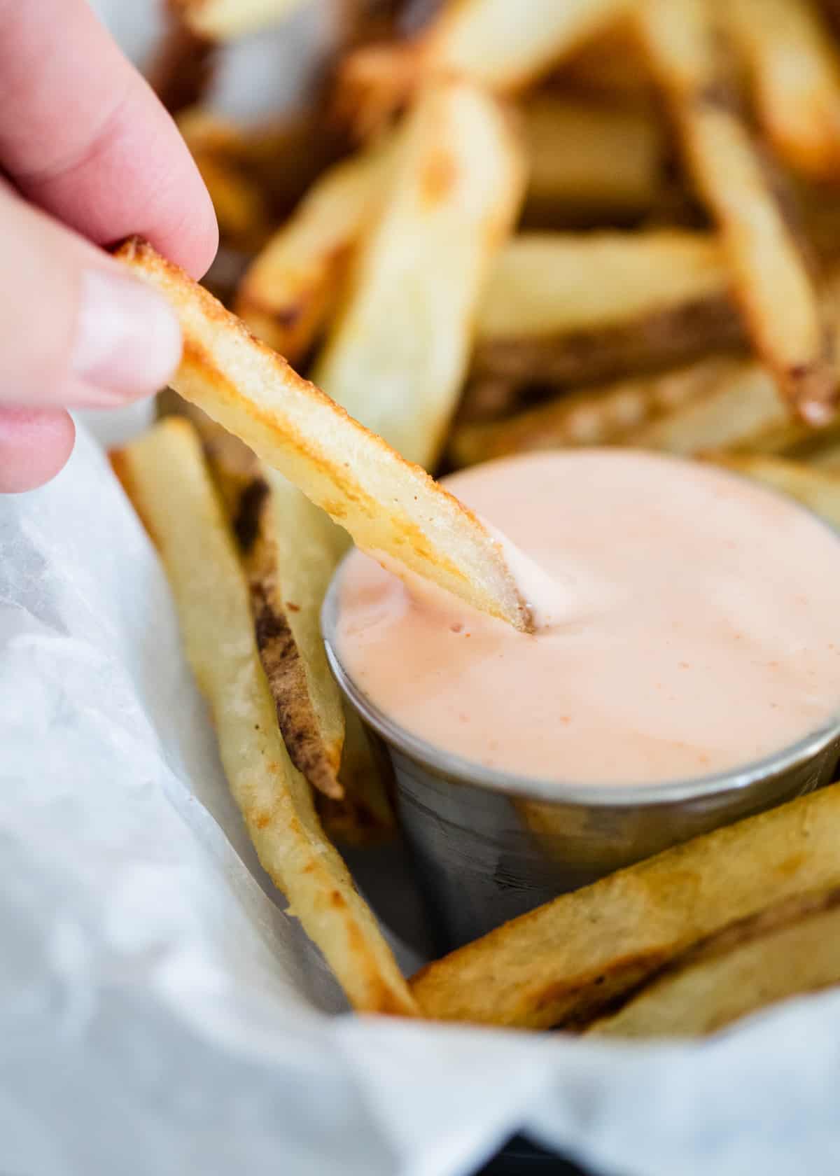 Fry sauce and french fries in basket.