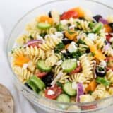 greek pasta salad in a glass bowl