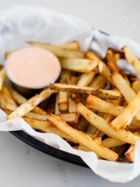 Homemade french fries in a basket.