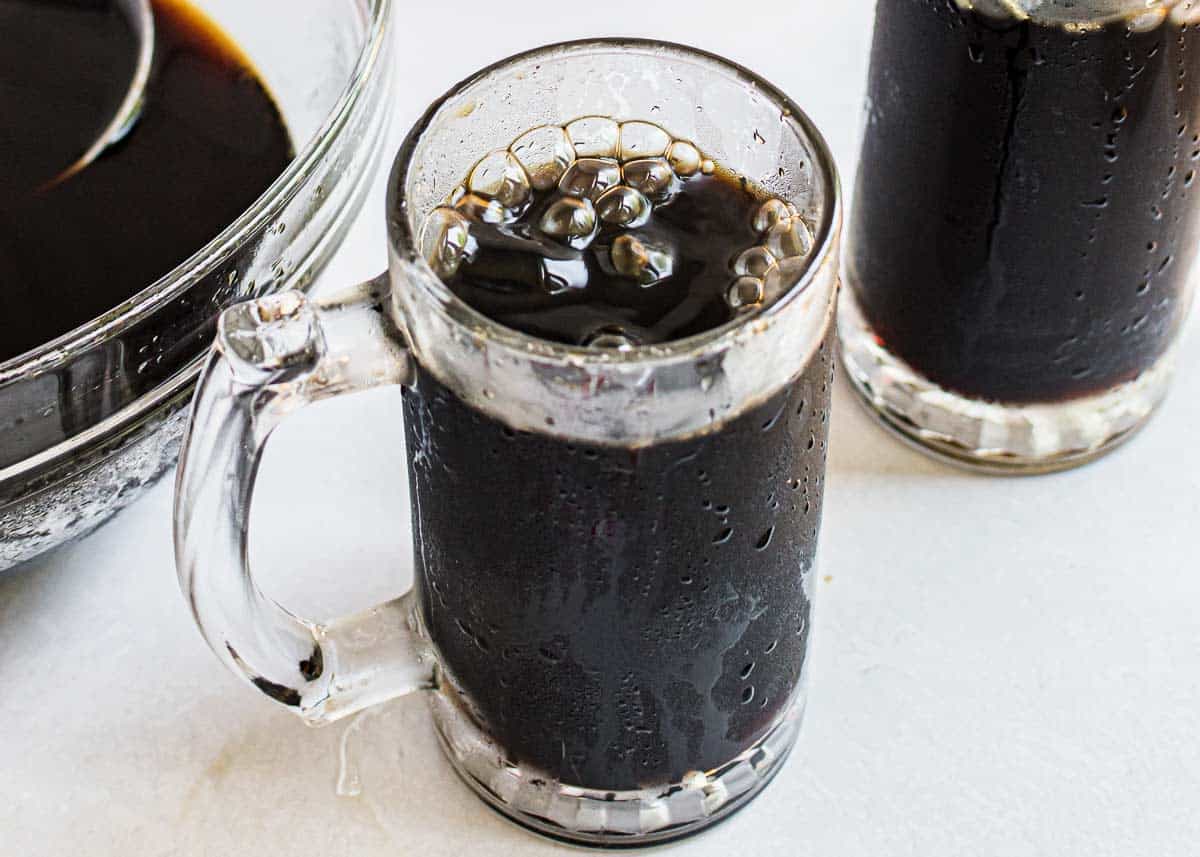 Homemade root beer in glass mug.