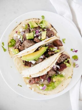 steak tacos on white plate