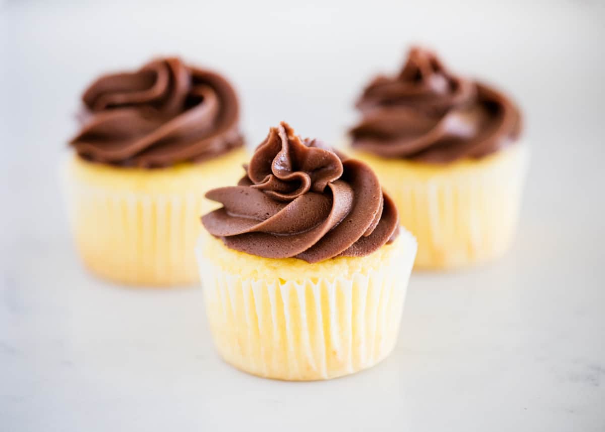 Vanilla cupcakes on counter.