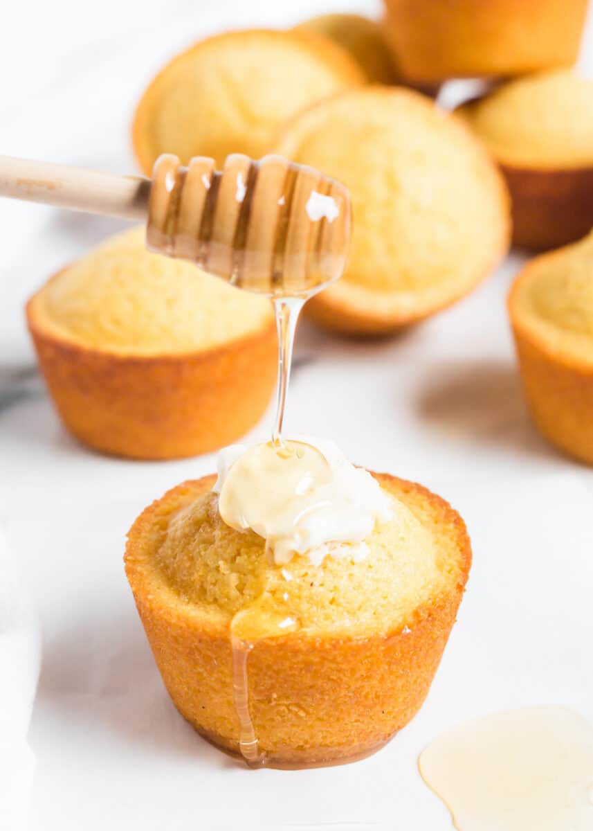 drizzling honey over cornbread muffins