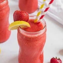 frozen strawberry lemonade with lemon on cup