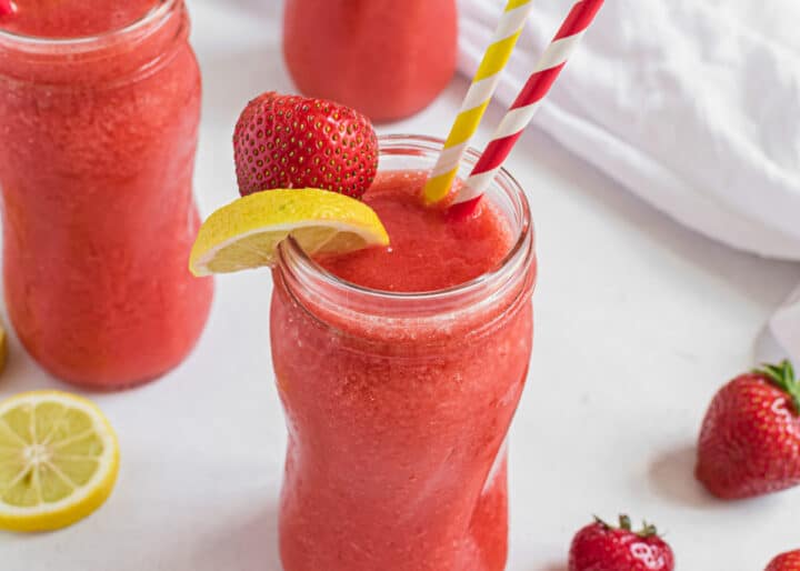 frozen strawberry lemonade with lemon on cup