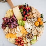 fruit and cheese platter on circle board