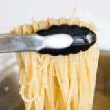 lifting pasta out of the pot with tongs