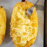 cooked spaghetti squash on baking sheet