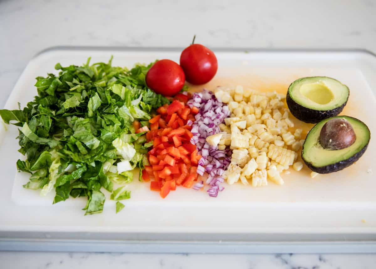 Salad vegetables on cutting board.
