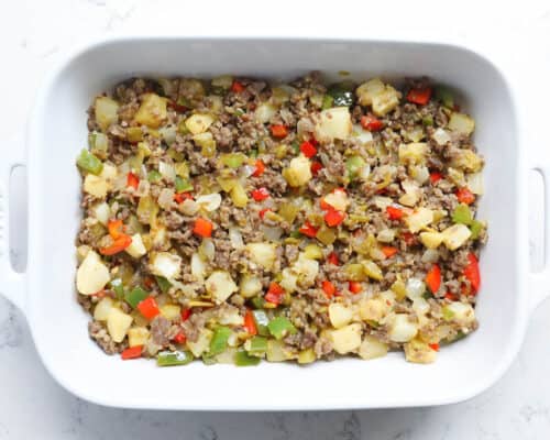 potato and sausage in white baking dish