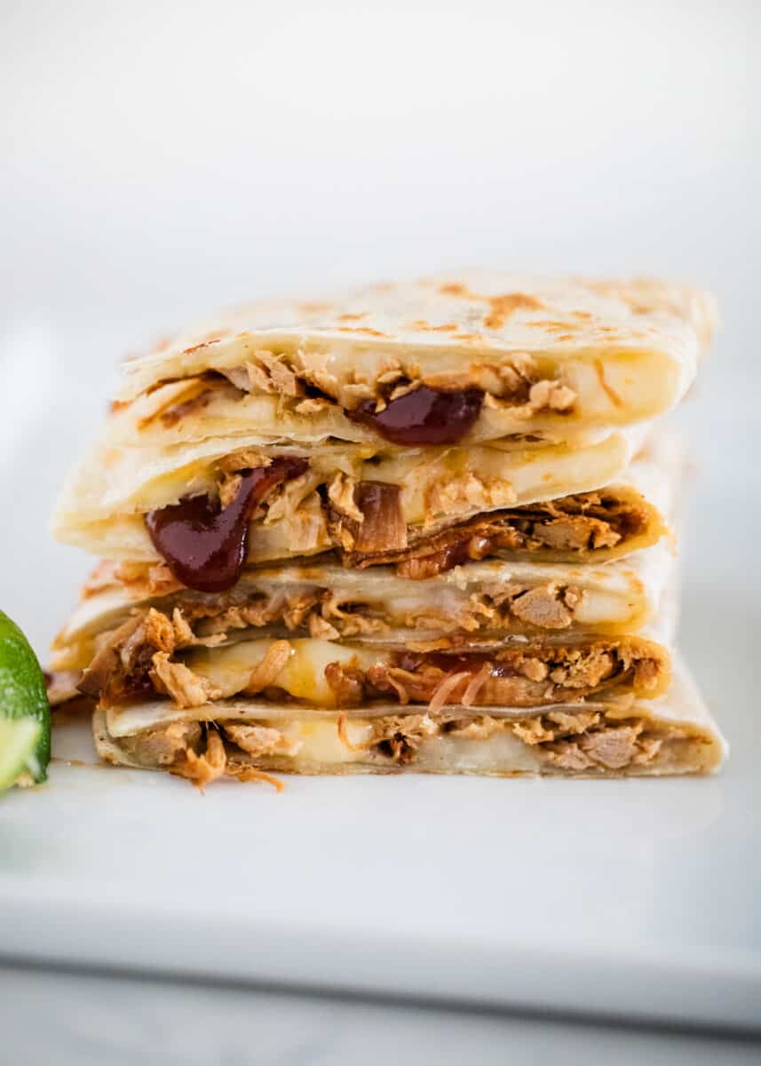 bbq pulled pork quesadilla slices stacked on plate 