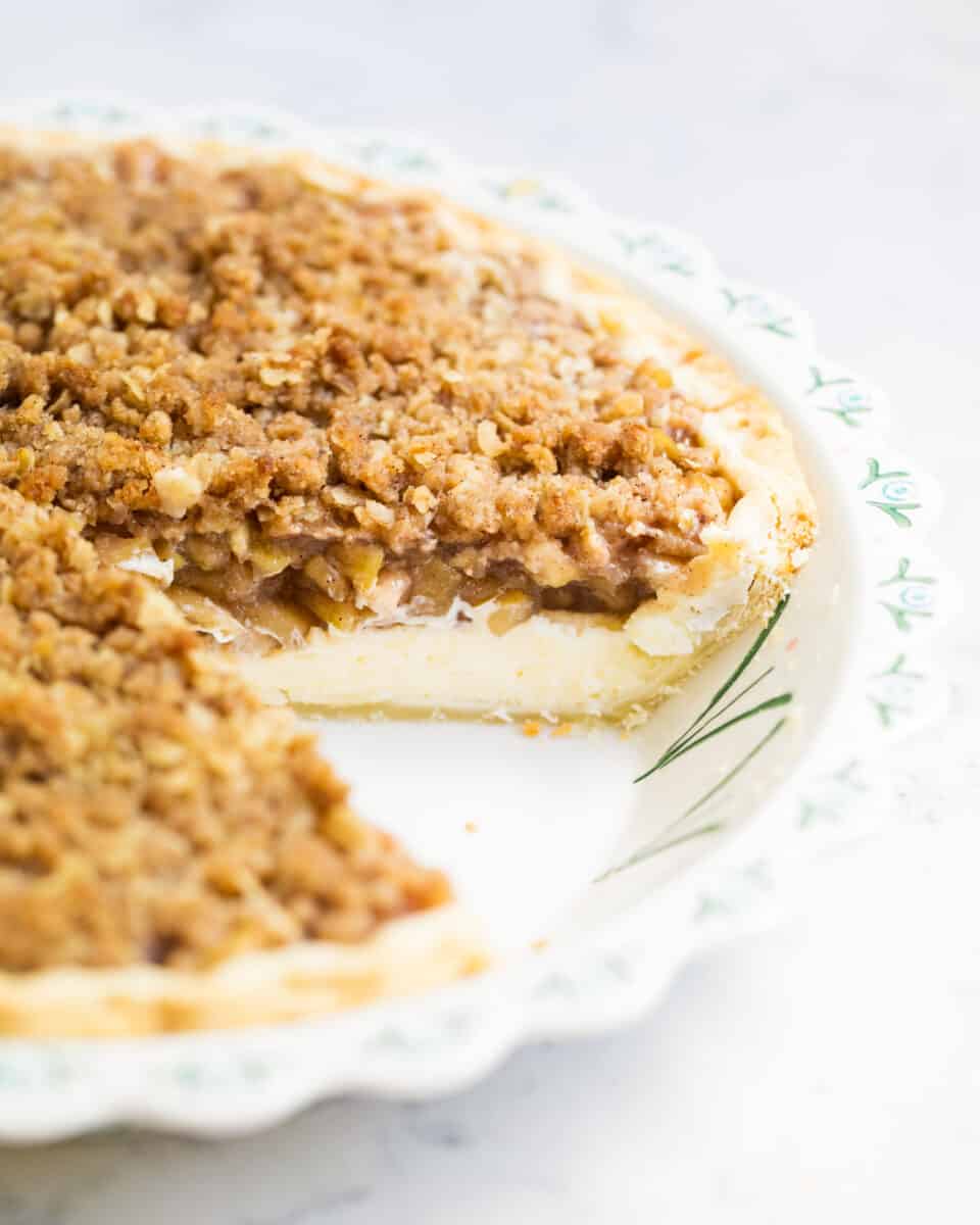 slice taken from apple cheesecake pie