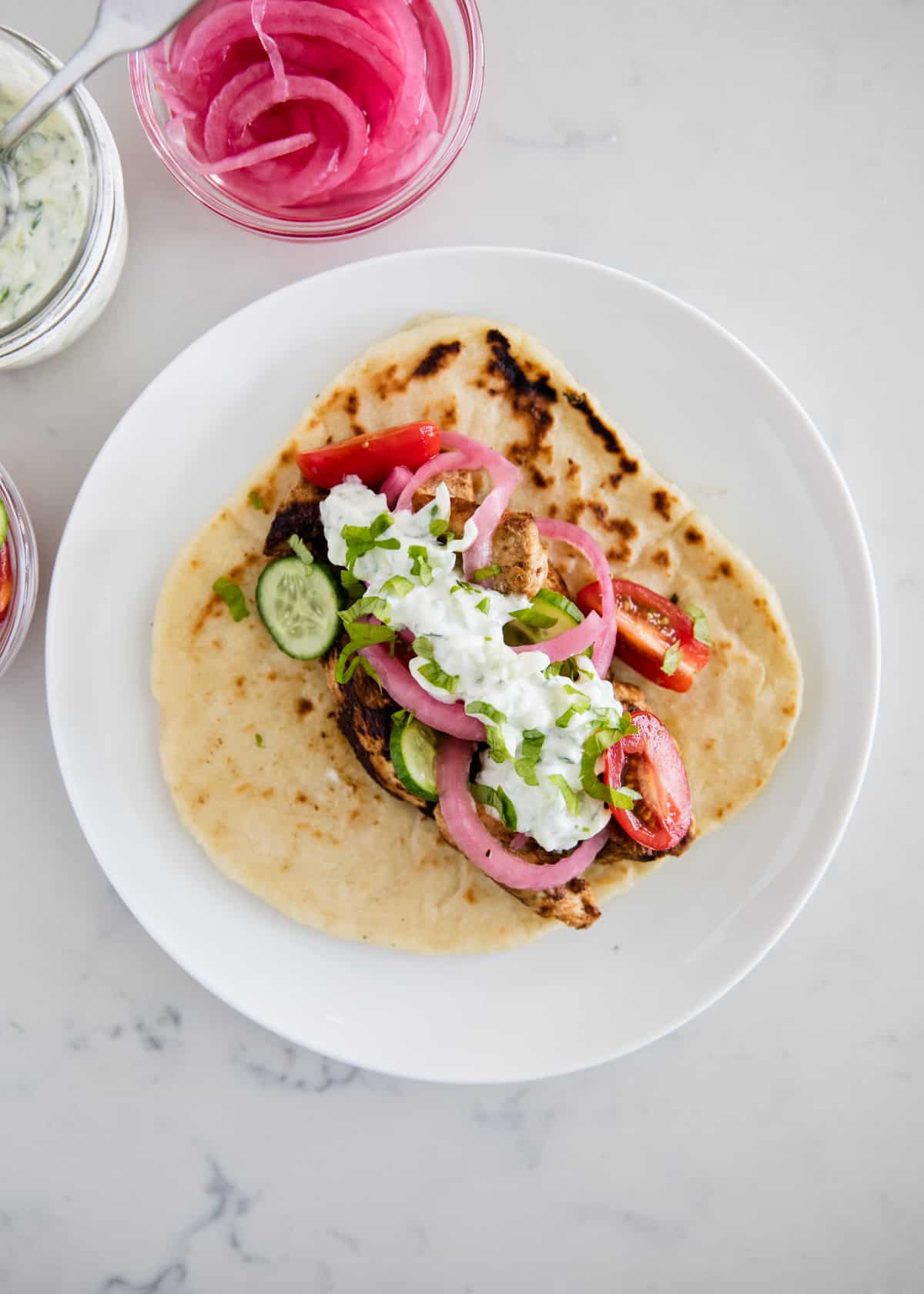 Chicken gyro laying flat on a plate.