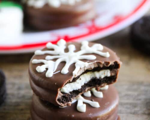 A close up of a christmas chocolate dipped oreo with a bite taken out