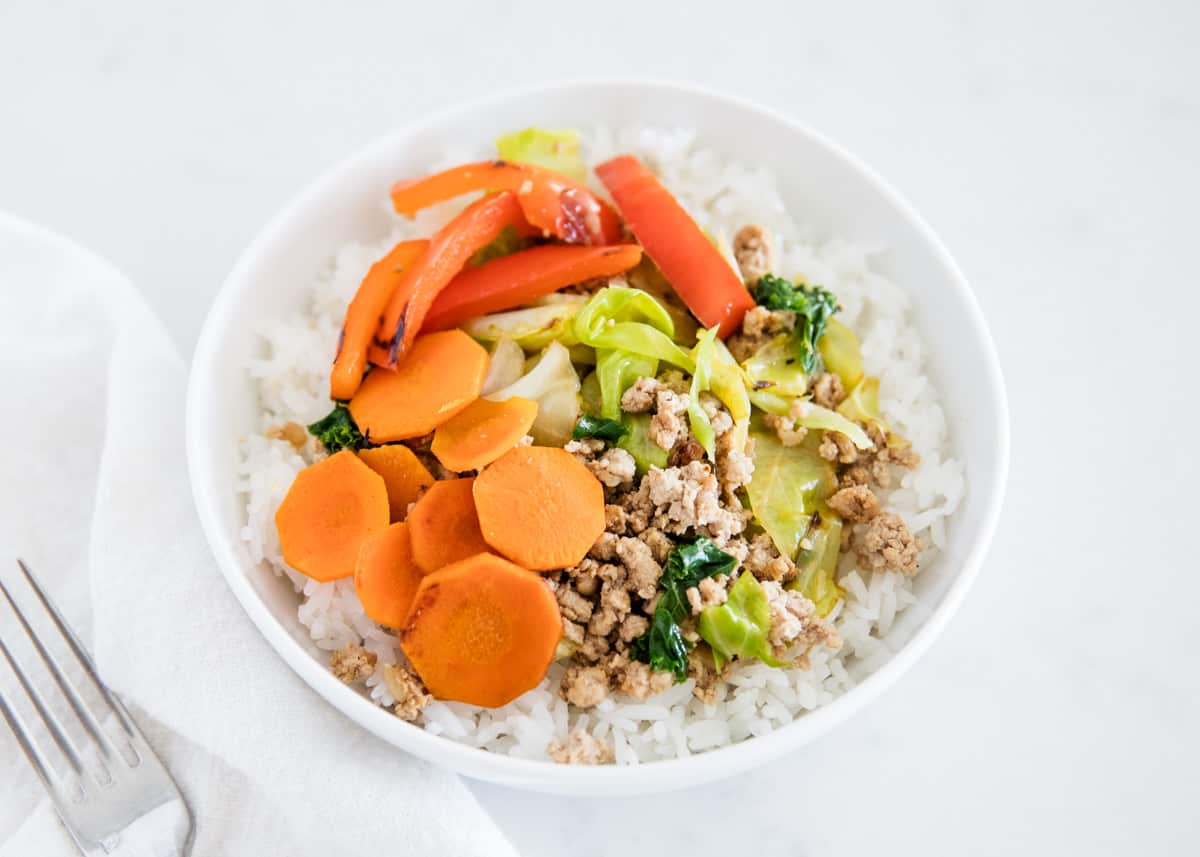 Egg roll in a bowl with rice.