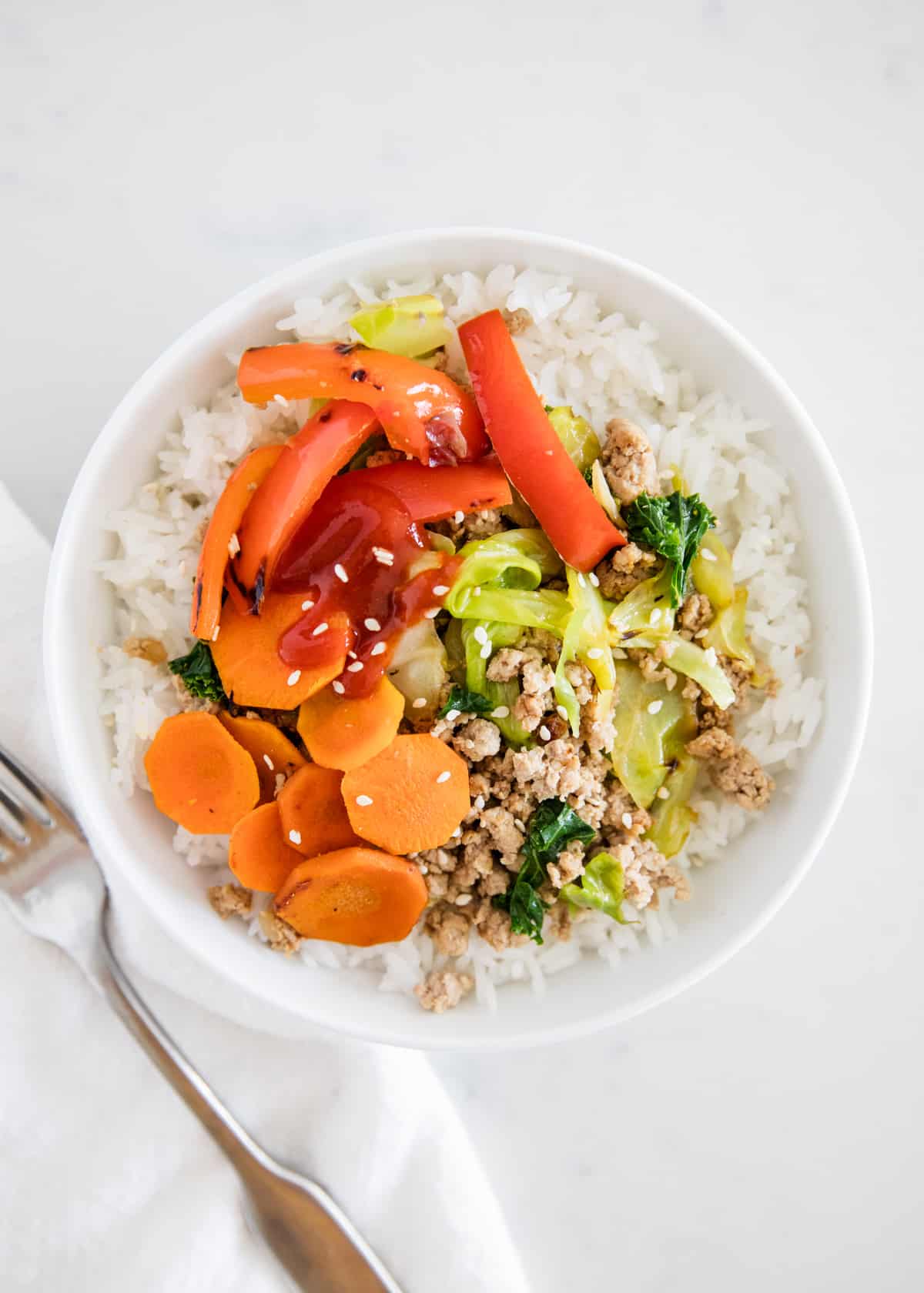 Ground turkey with vegetables and rice in bowl.