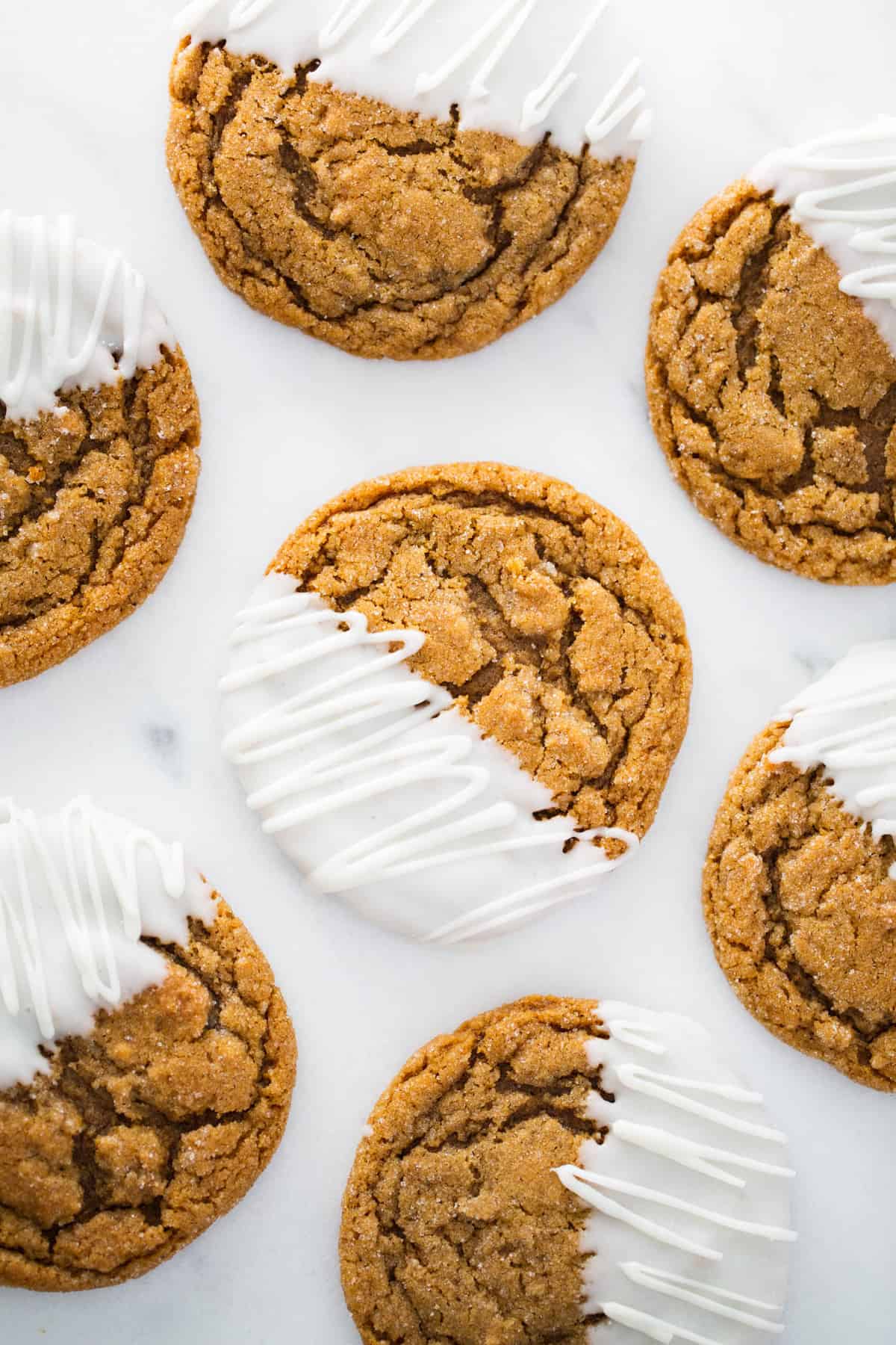 Molasses cookies with half dipped in white chocolate.