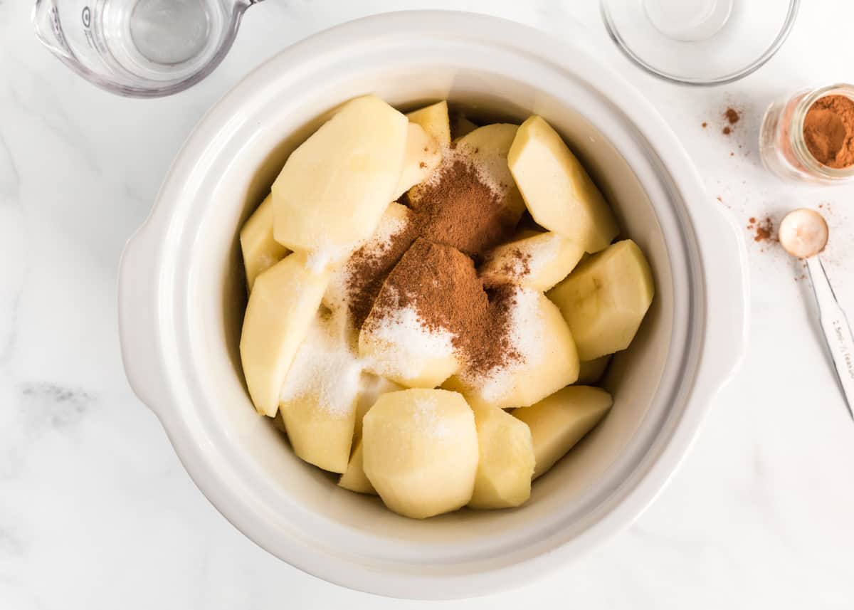 Apples and cinnamon in a crockpot.