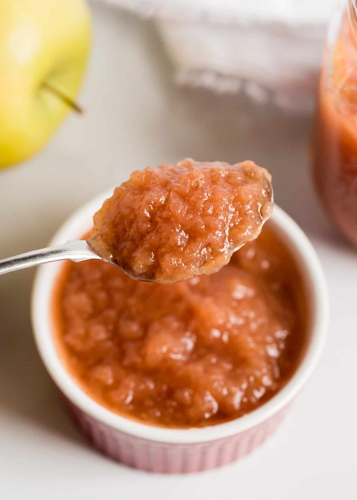 Crockpot applesauce made with only a few ingredients and SO delicious! Once you've made this homemade version, you'll never go back to store bought. So easy and fresh! Spoon of applesauce.
