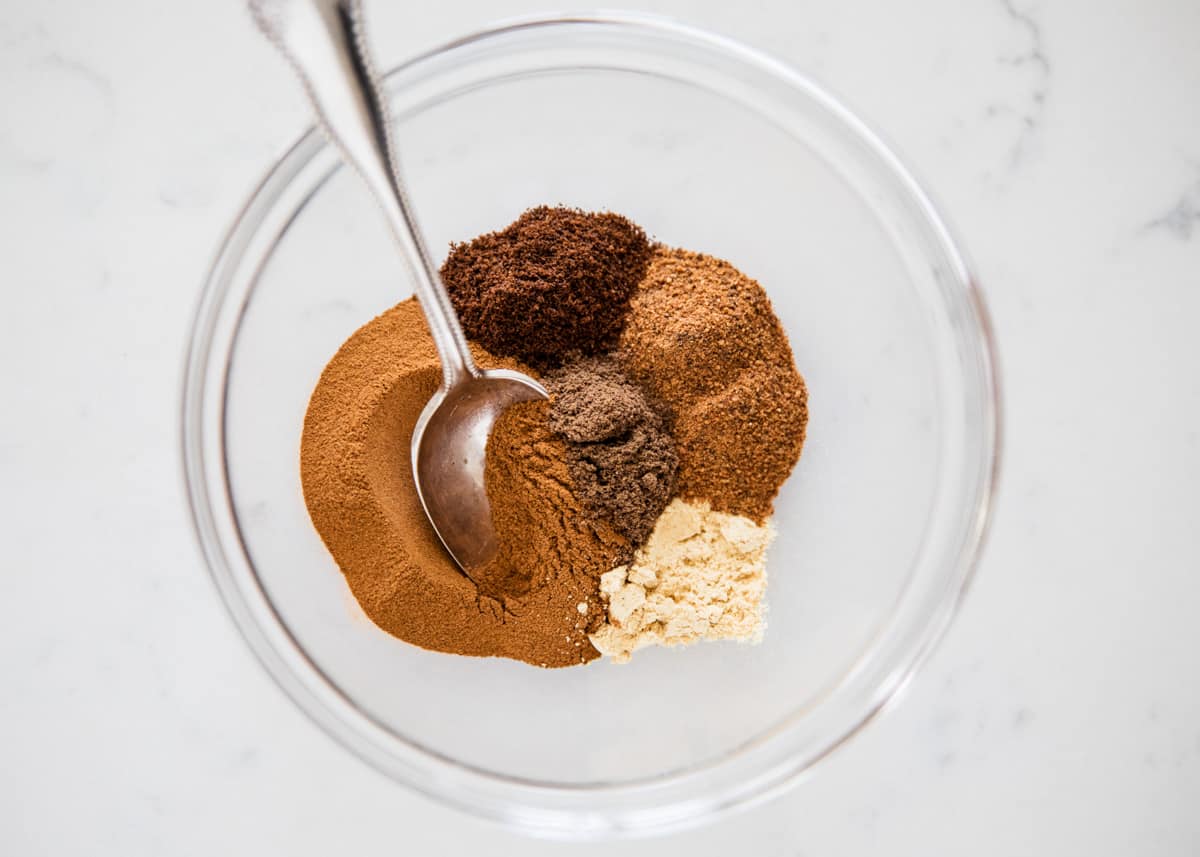 Mixing pumpkin pie spice in bowl.