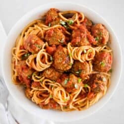 spaghetti and meatballs on white plate