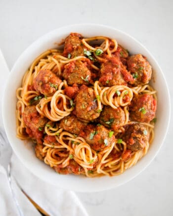 spaghetti and meatballs on white plate