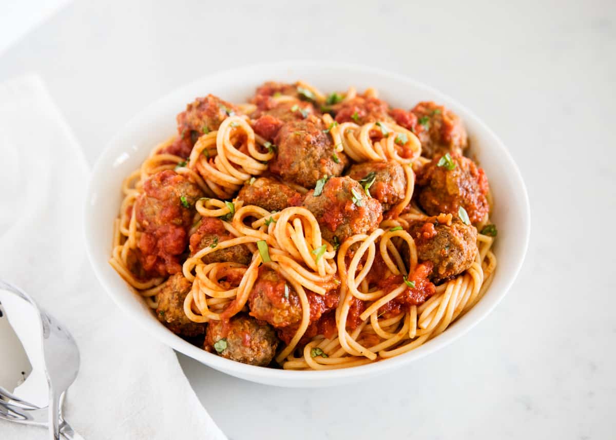 Juicy, tender meatballs simmered with marinara and then tossed with spaghetti noodles. These homemade spaghetti and meatballs taste like they came straight from an Italian restaurant! Plate of spaghetti and meatballs.