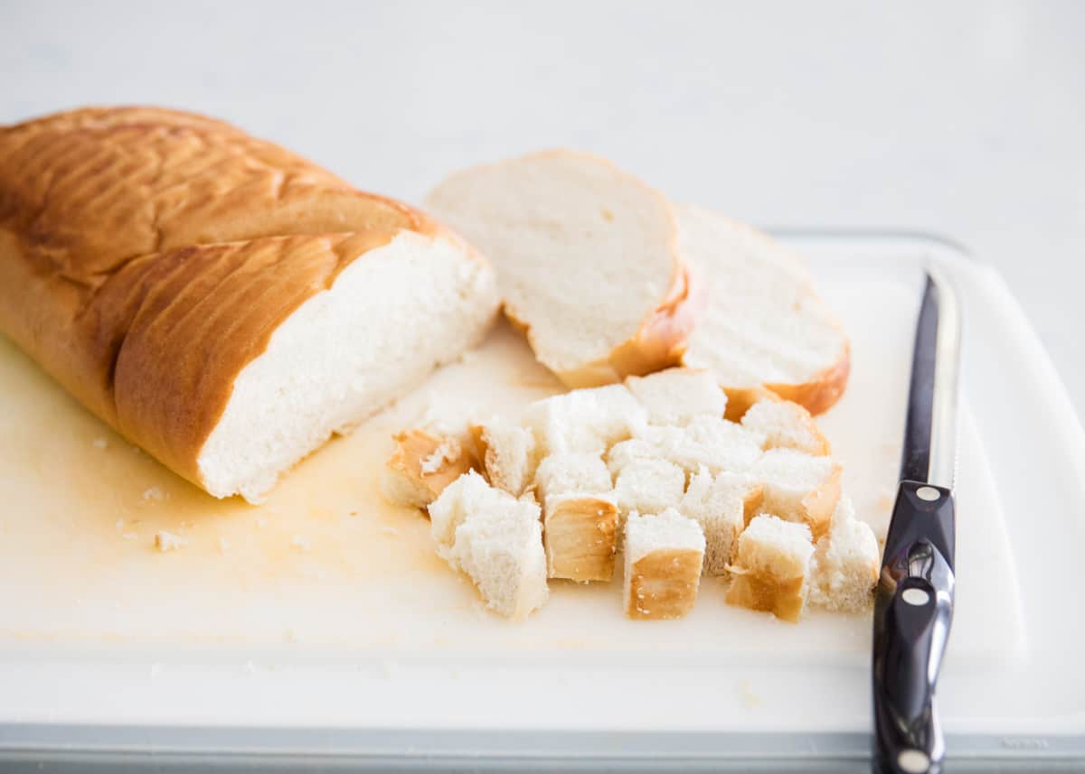 Cutting bread on cutting board.