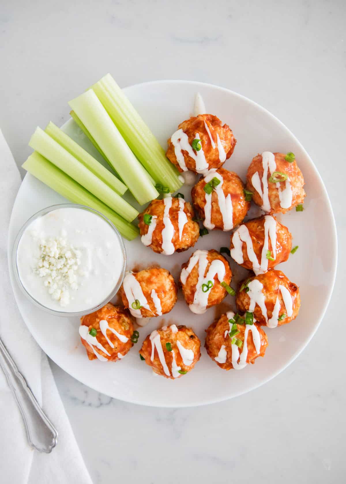Tender and juicy buffalo chicken meatballs coated in a tangy buffalo sauce. These meatballs make the perfect easy appetizer and are great for dipping in your favorite sauce! Buffalo chicken meatballs with blue cheese.