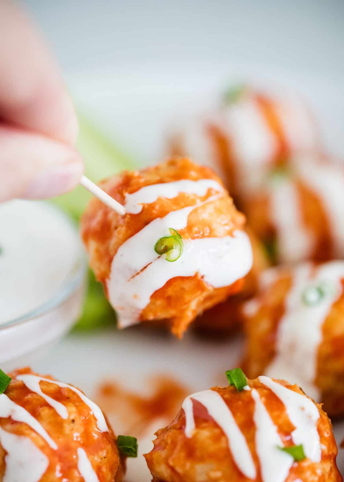 Buffalo chicken meatball on toothpick.