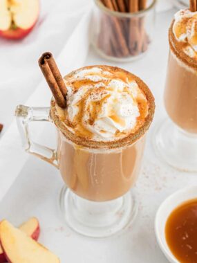 glass cup with caramel apple cider and cinnamon
