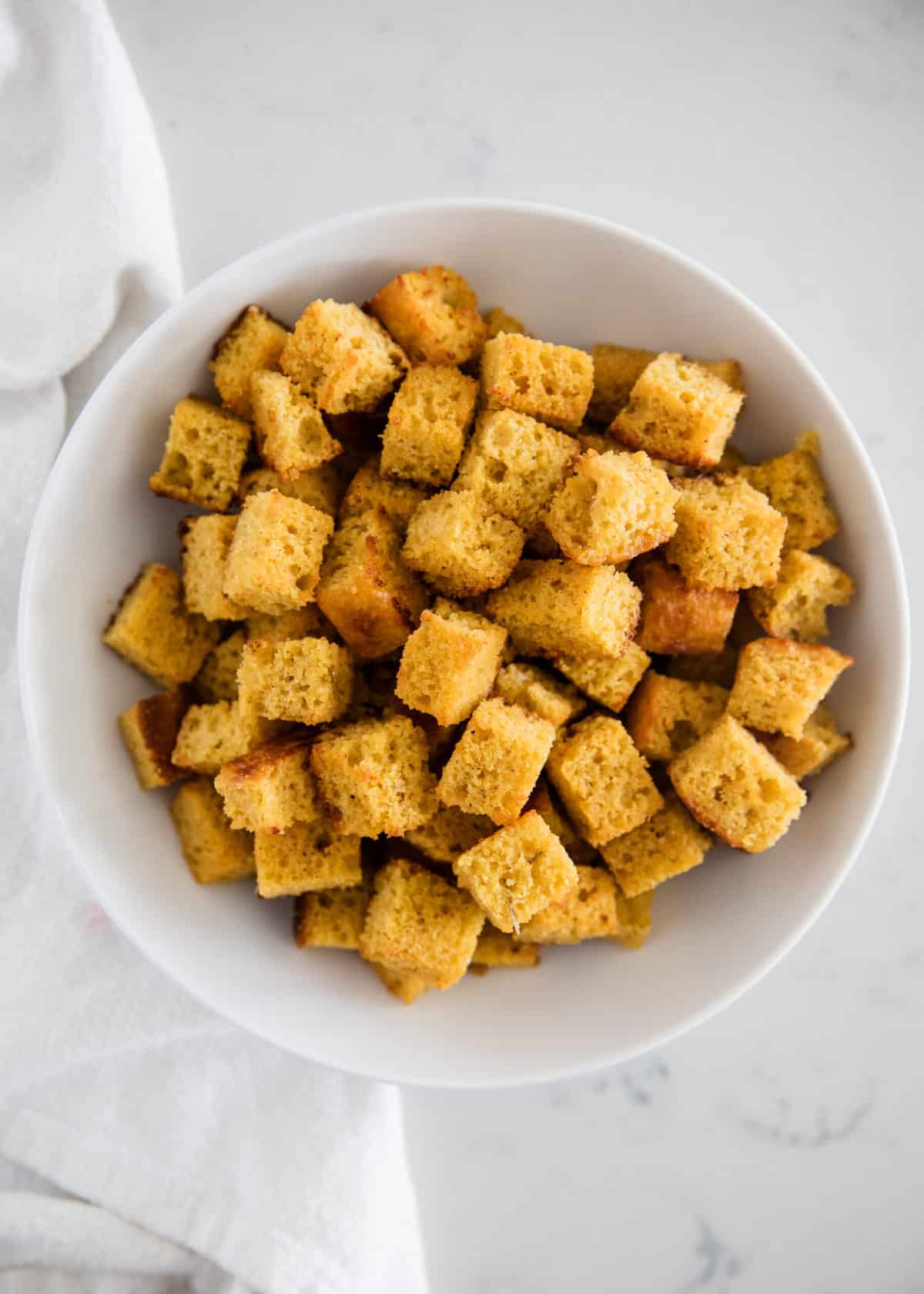 Cornbread croutons in bowl.