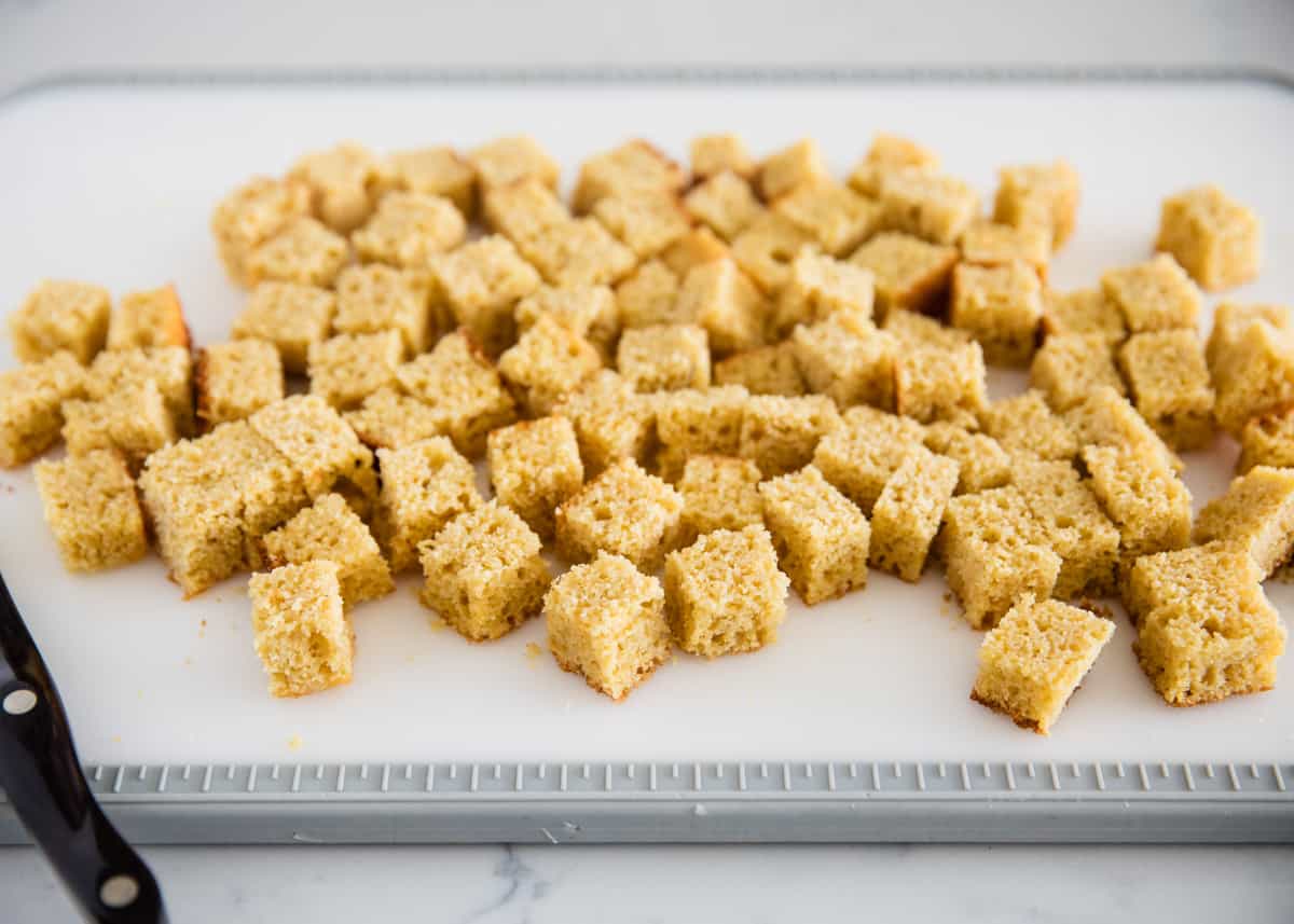 Cornbread cubes on cutting board.